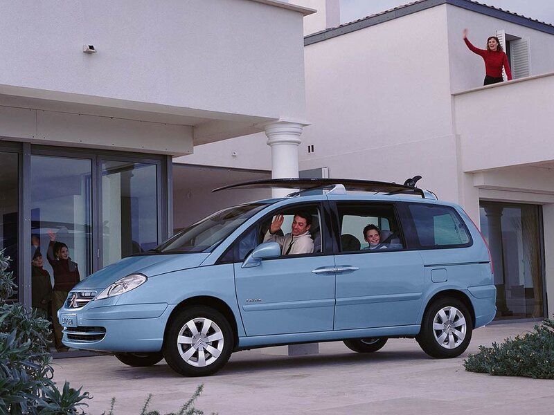 Family in light blue minivan