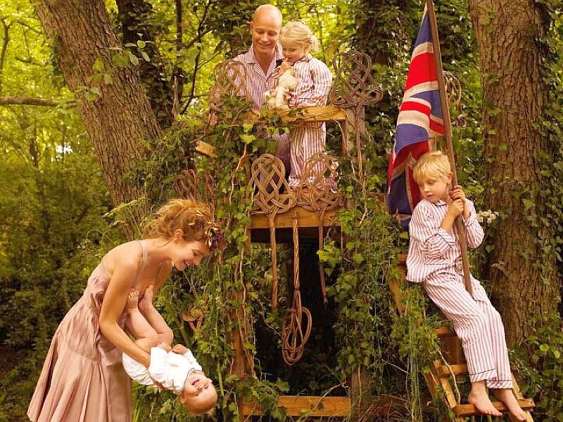 Family in treehouse with flag