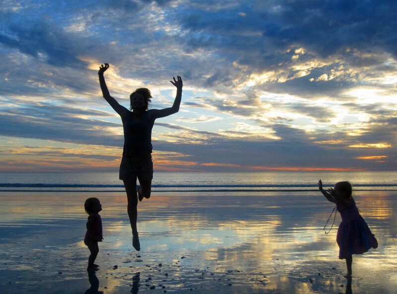 Family jumping on the beach