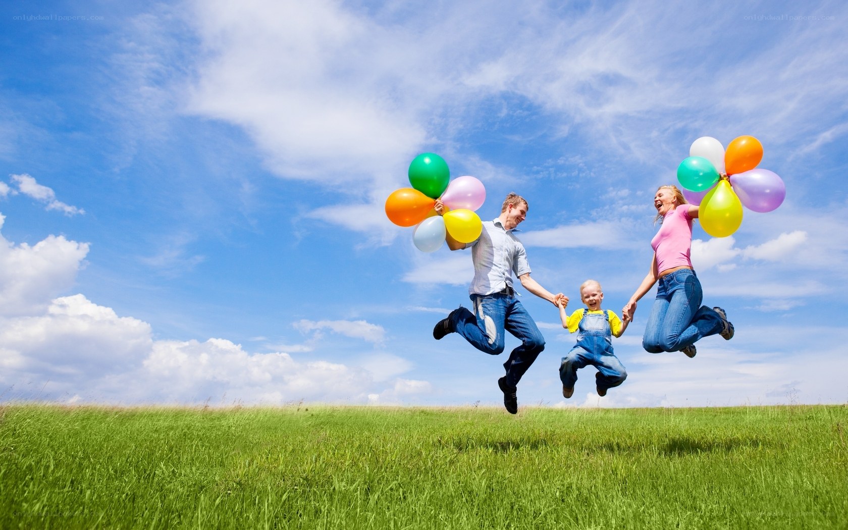 Family jumping with balloons