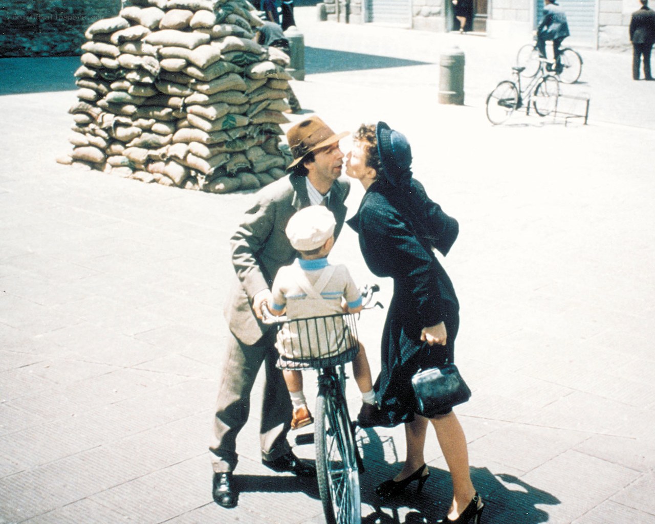 Family kissing on a city street