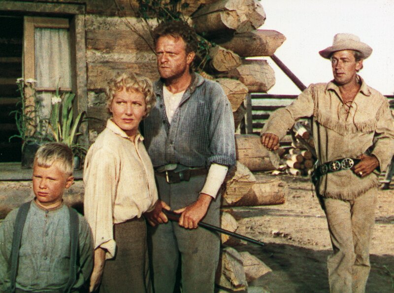 Family outside log cabin