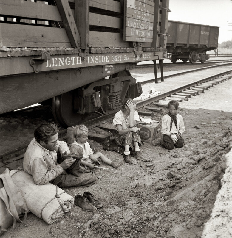 Family resting by train car