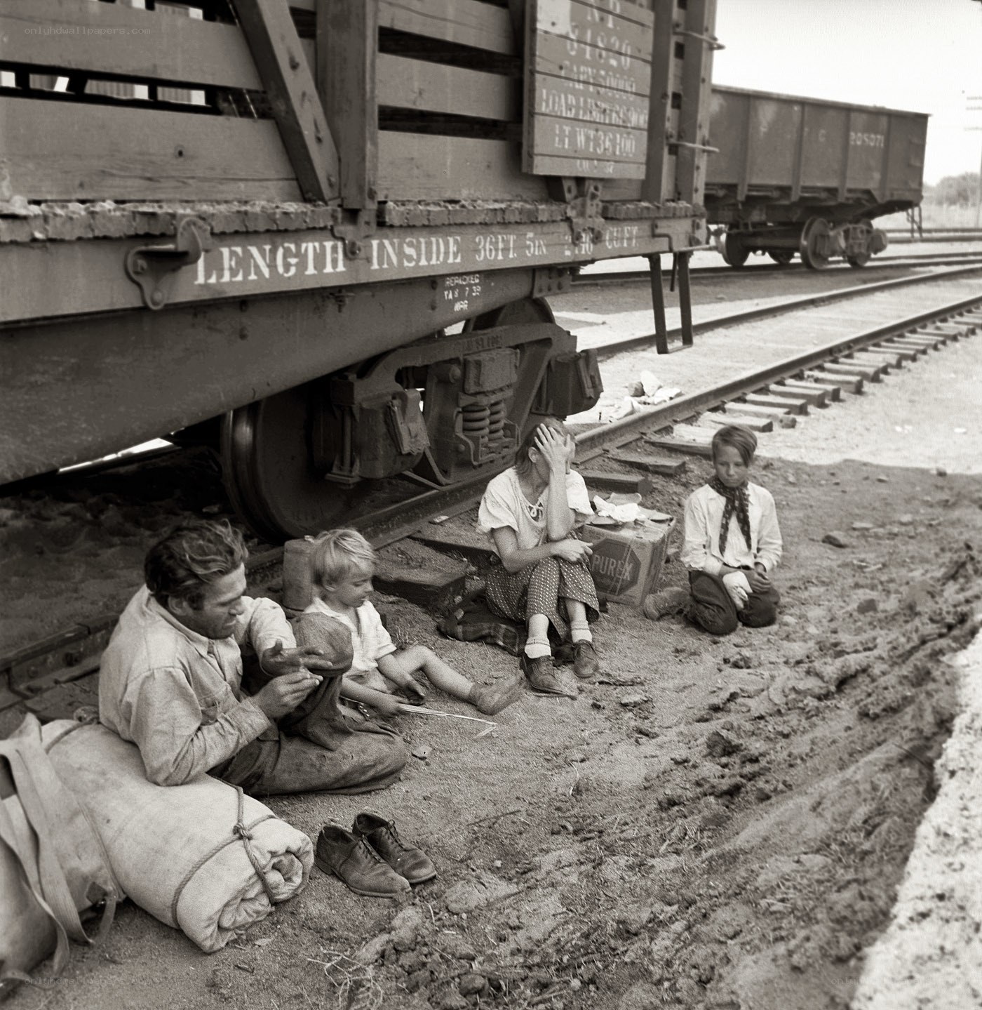 Family resting by train car