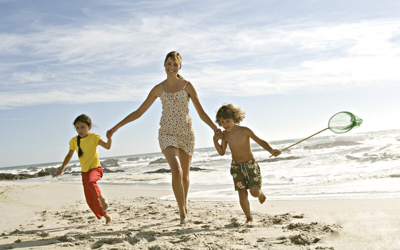 Family running on the beach