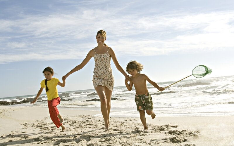 Family running on the beach