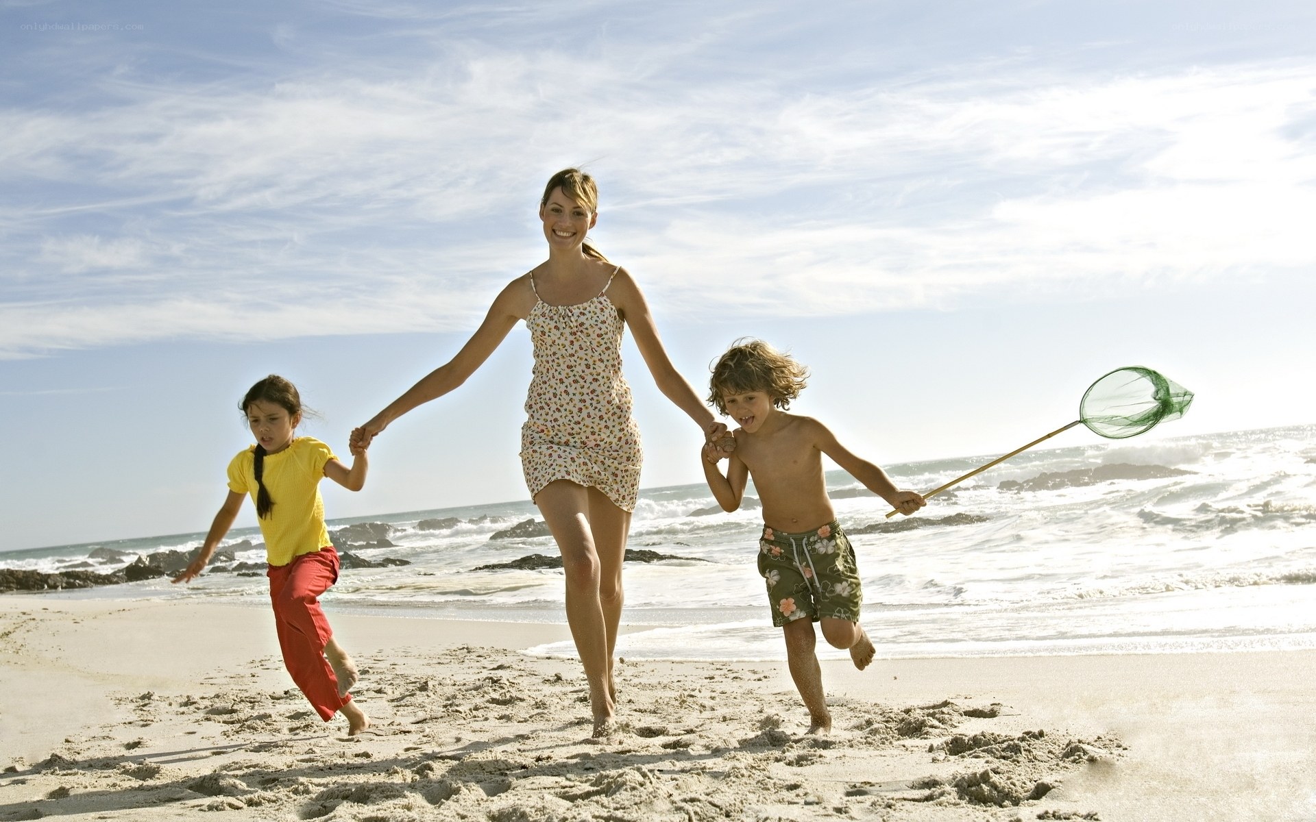 Family running on the beach