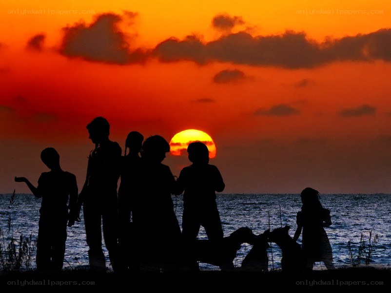 Family silhouettes at sunset