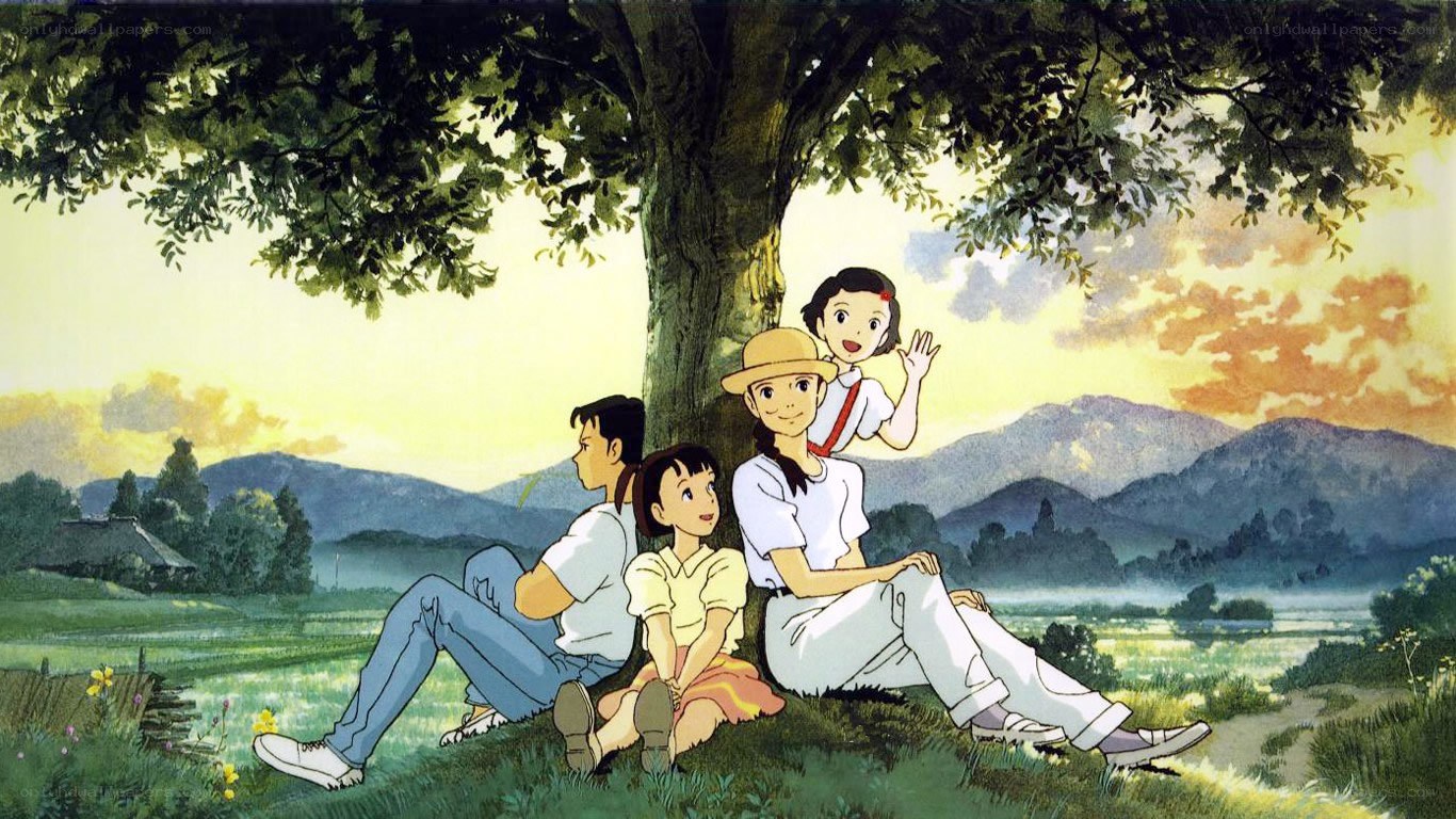 Family under a tree at sunset
