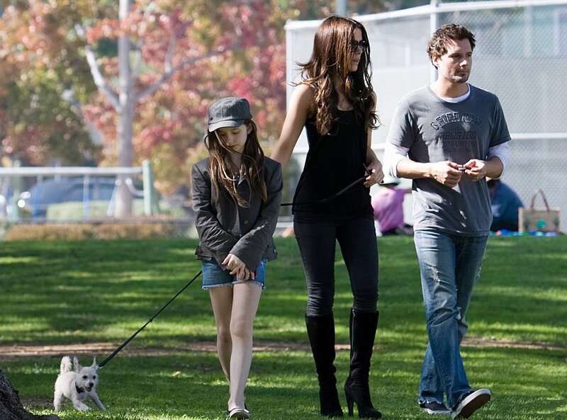 Family walking dog in park