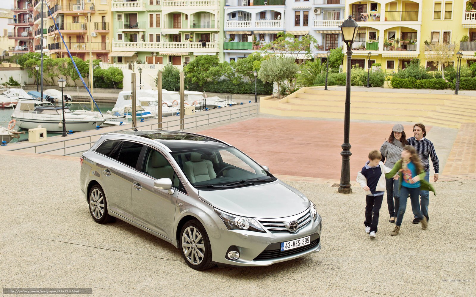 Family with car by harbor