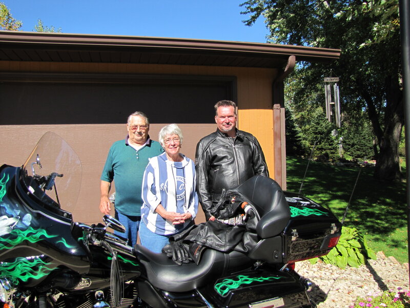 Family with motorcycles in driveway