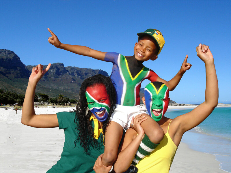 Family with painted faces at beach