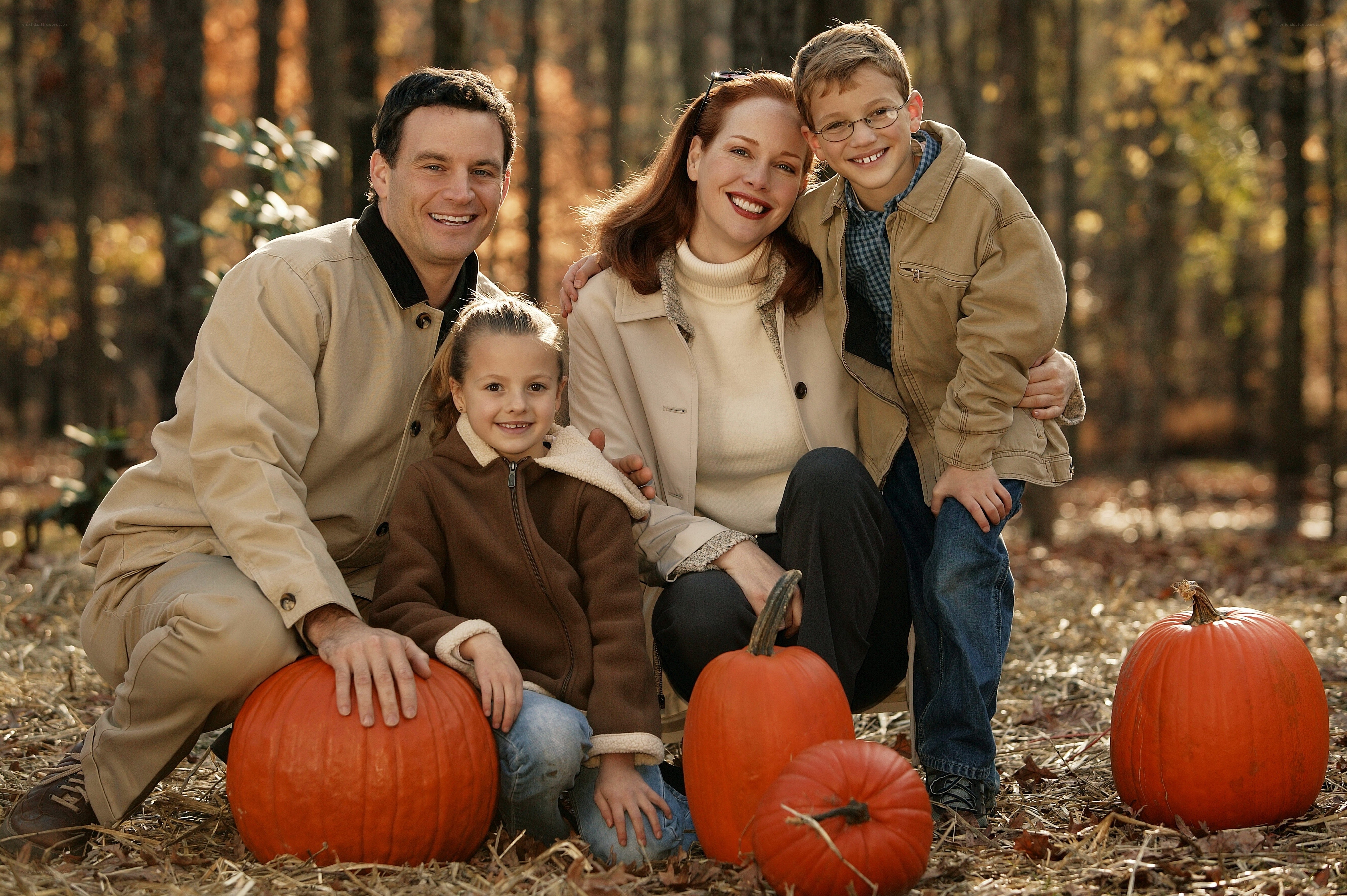 Family with pumpkins in autumn