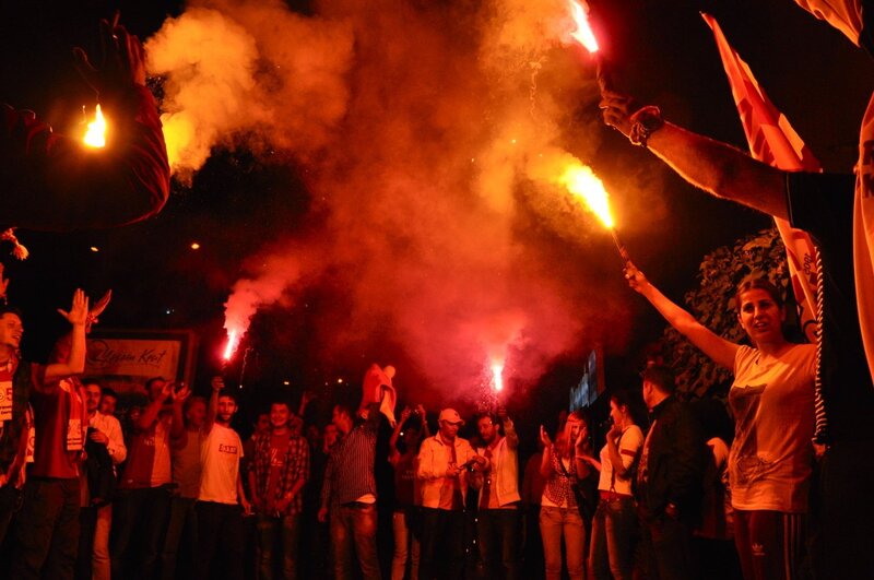 Fans celebrating with flares