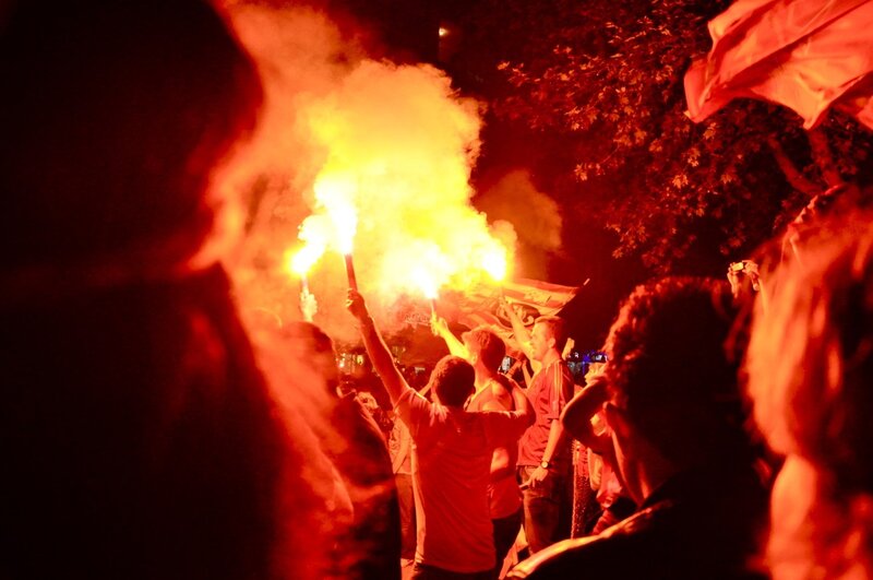 Fans with flares at night
