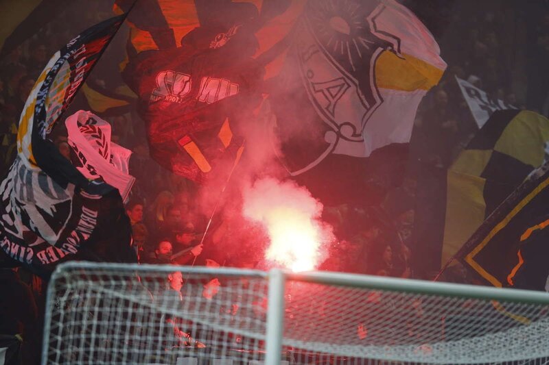 Fans with Flares in Stadium — Red, Intense, Dramatic