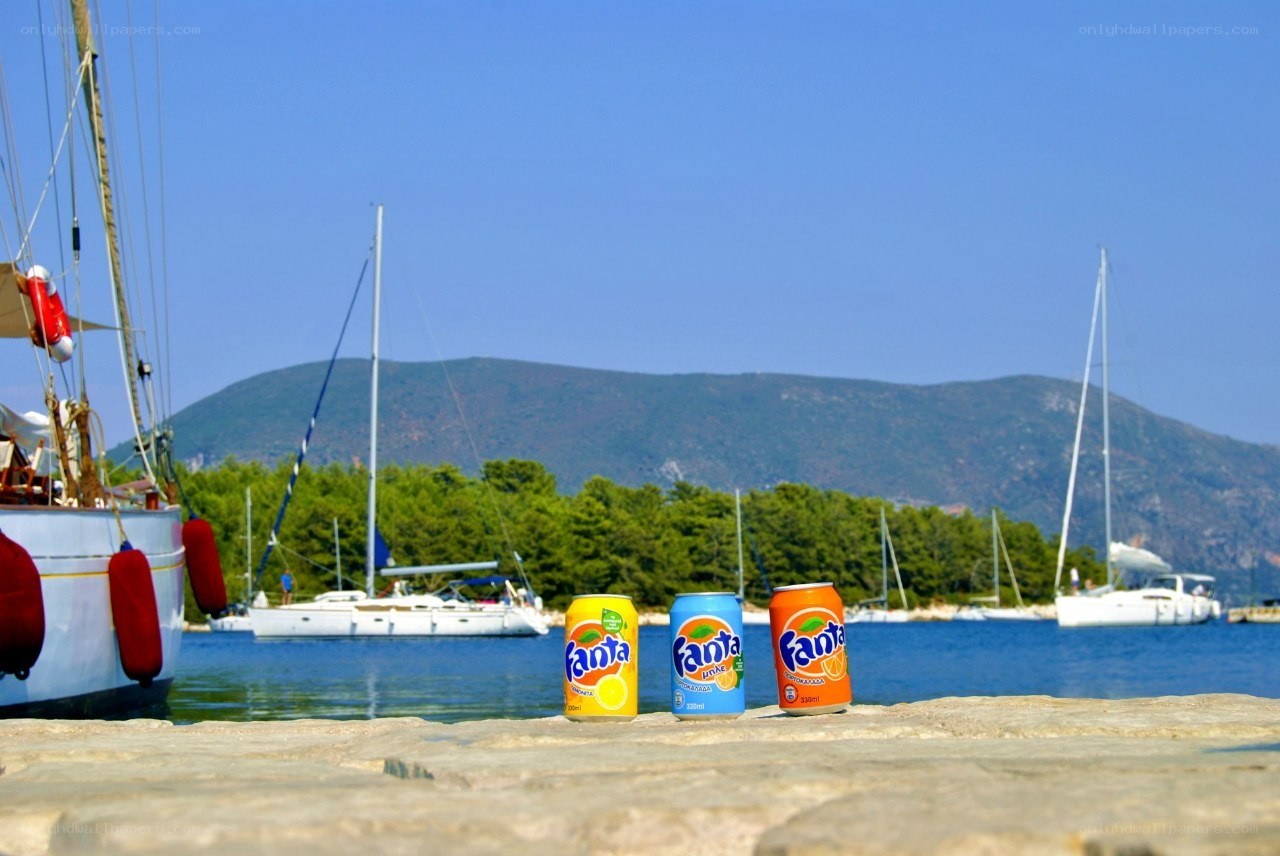 Fanta cans on a sunny dock