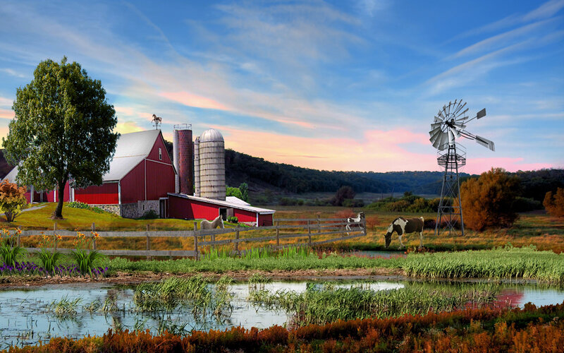 Farm at sunset with windmill