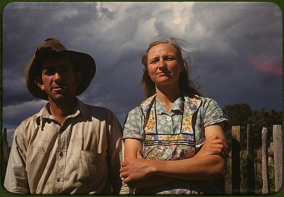 Farm couple under stormy sky
