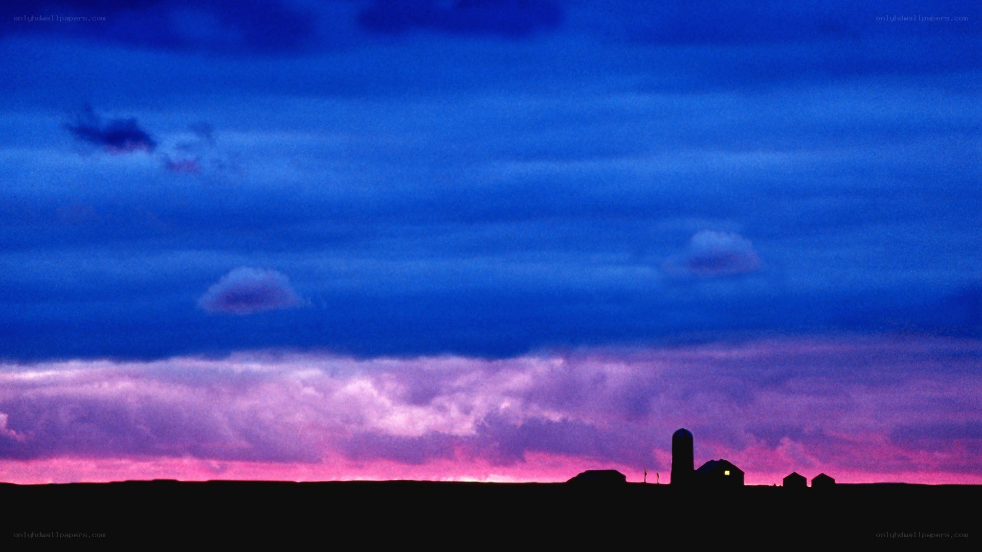 Farm silhouetted at dusk