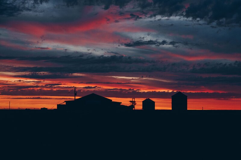 Farm silos at sunset