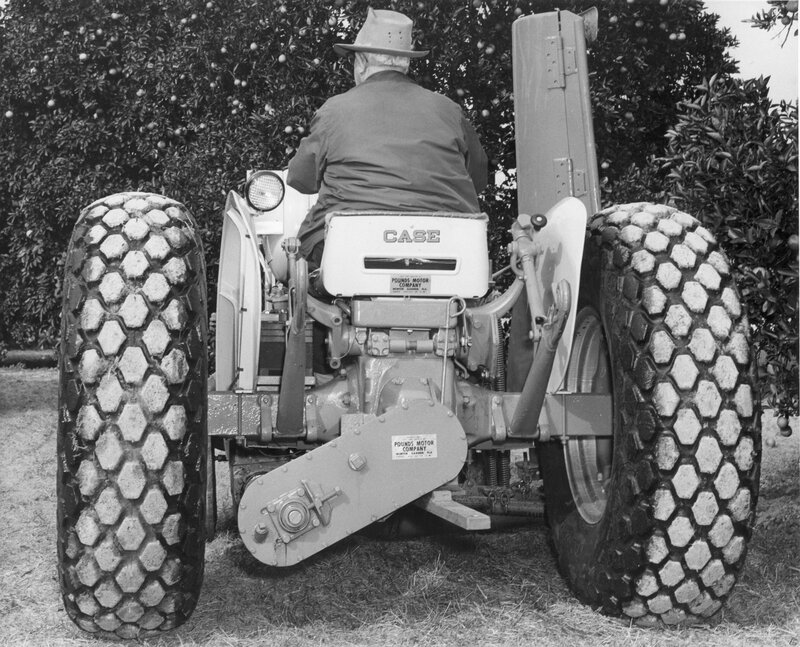 Farmer on a tractor in an orchard
