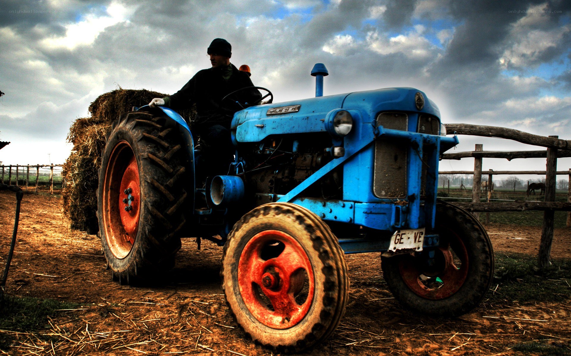 Farmer on blue tractor