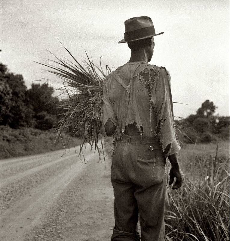 Farmer walking with bundle