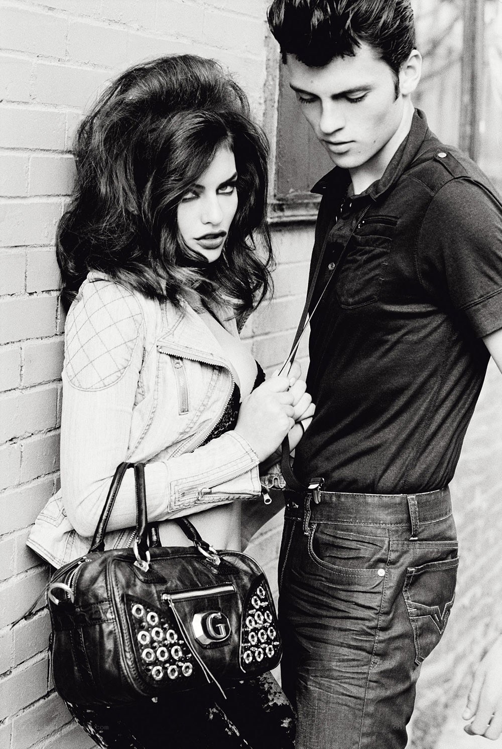 Fashion couple against brick wall