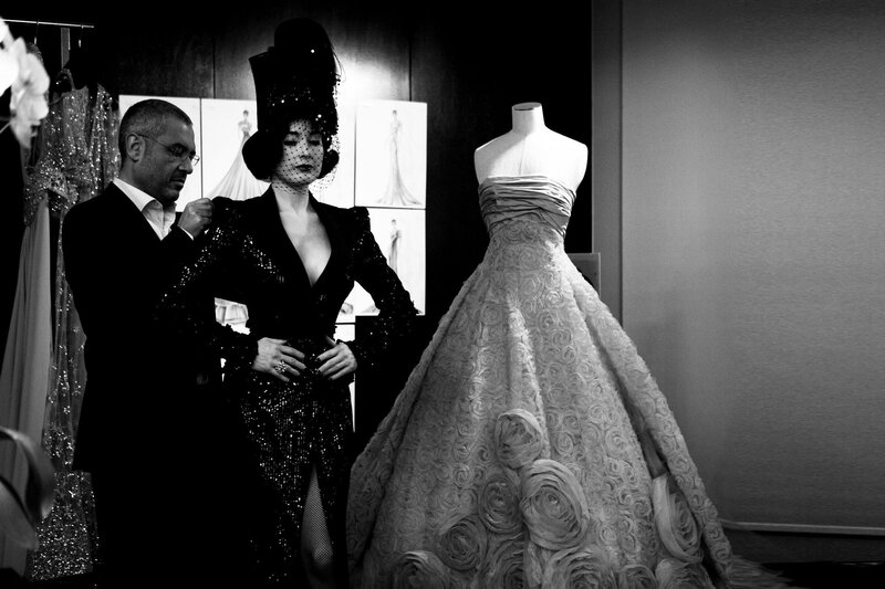 Fashion designer with model and gown