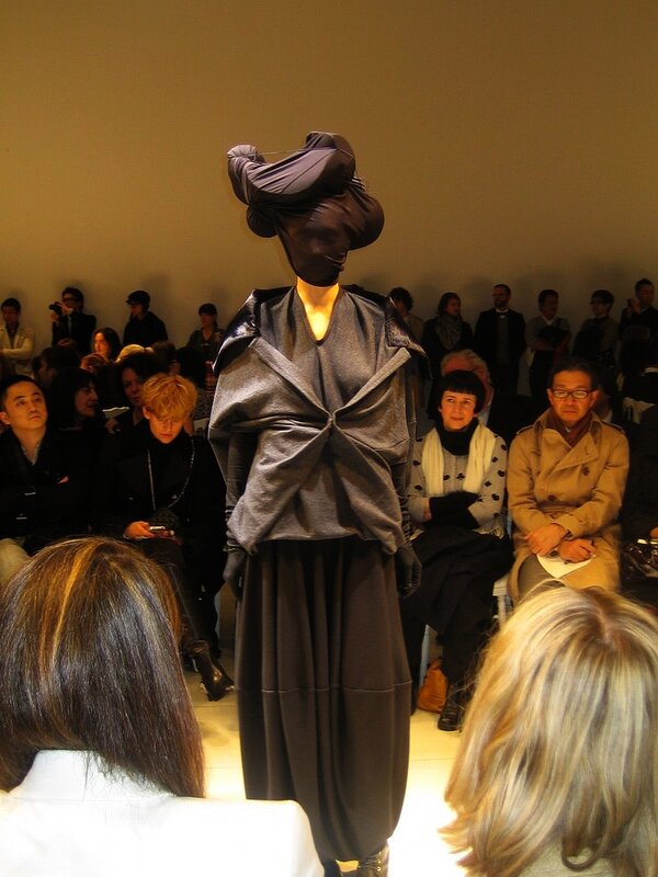 Fashion show model with avant-garde headpiece