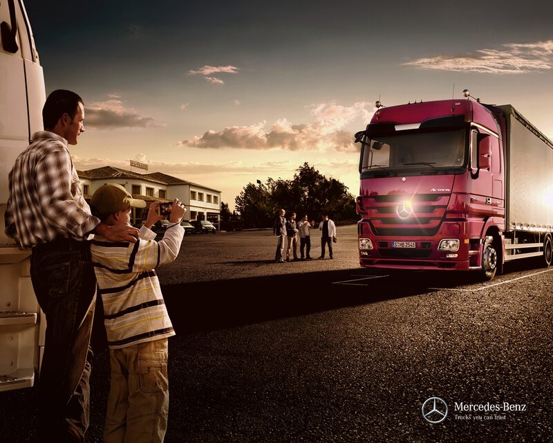 Father and son photographing a truck