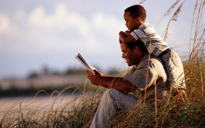 father and son reading together