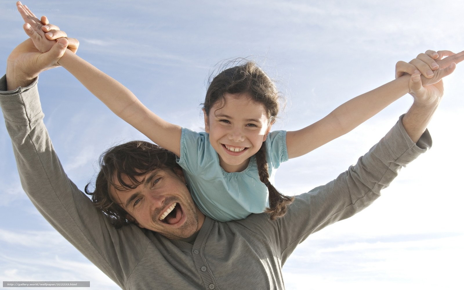 Father giving daughter a piggyback ride