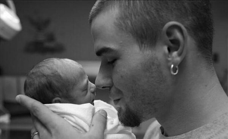 father holding newborn baby