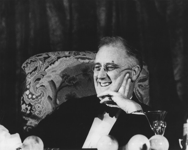 FDR laughing at a table