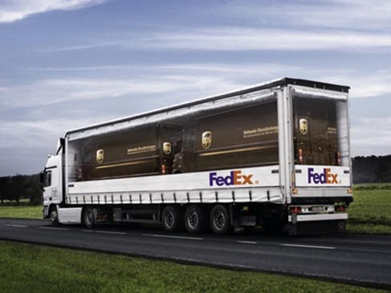 FedEx and UPS truck on road