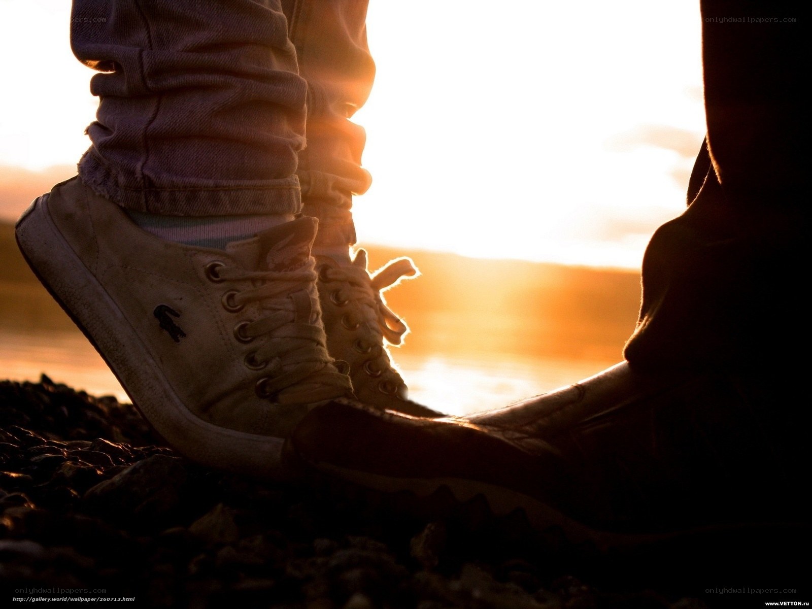 feet at sunset by water