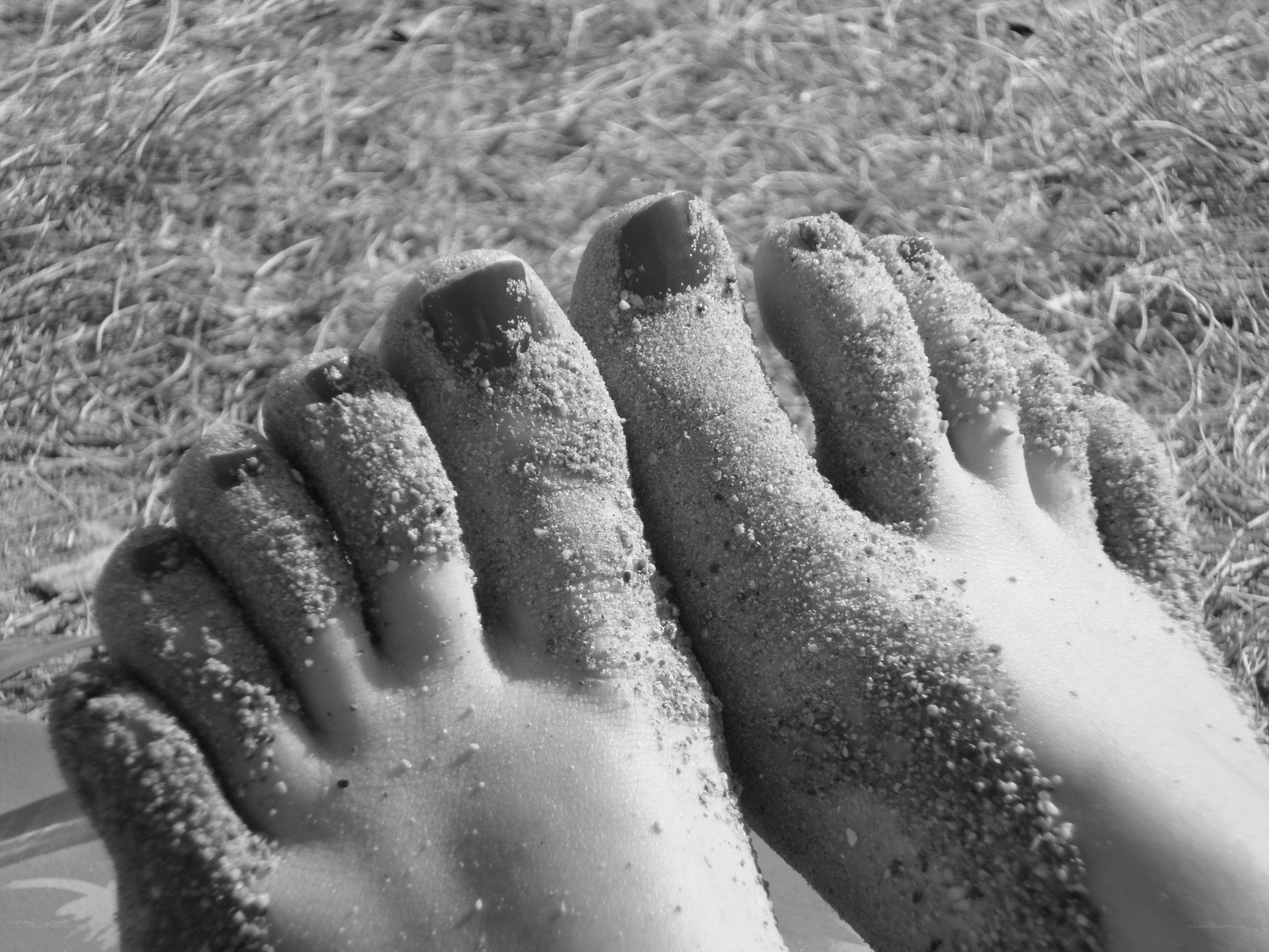 feet covered in sand