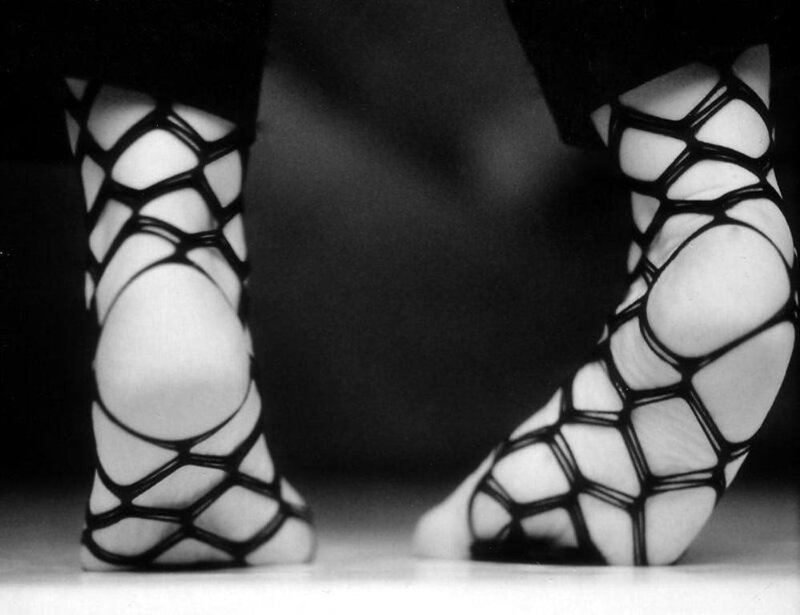 feet in black mesh sandals