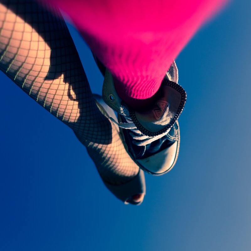 feet in fishnet tights and sneakers