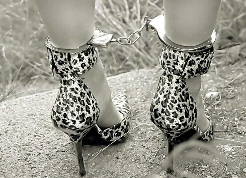 feet in high heels with handcuffs
