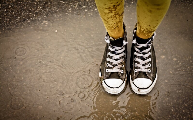feet in rain puddle