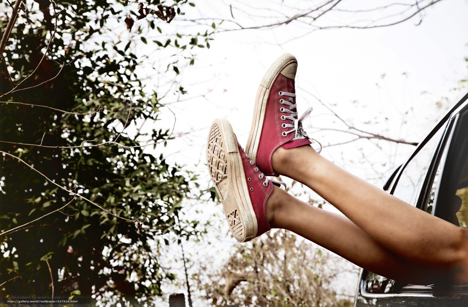 feet in red sneakers