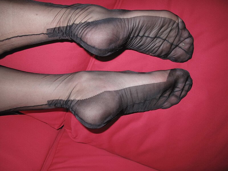 feet in sheer black stockings