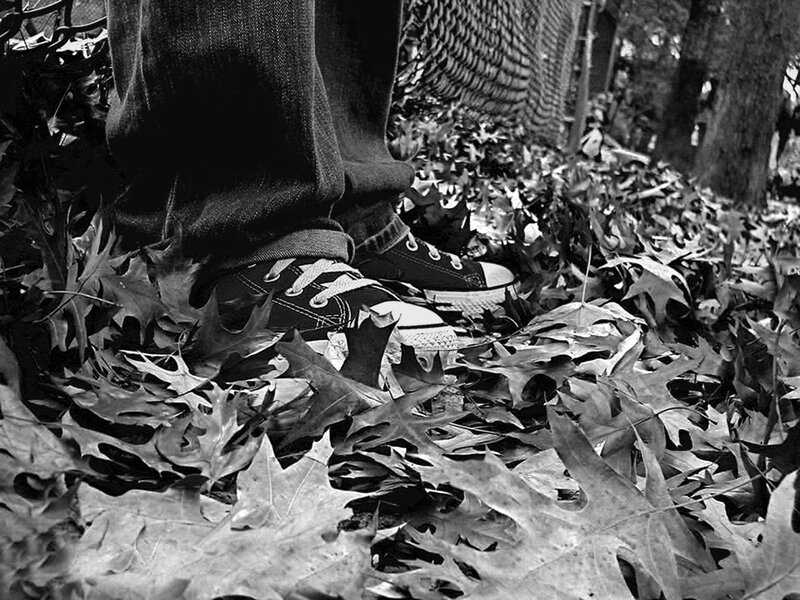 feet in sneakers on leaves