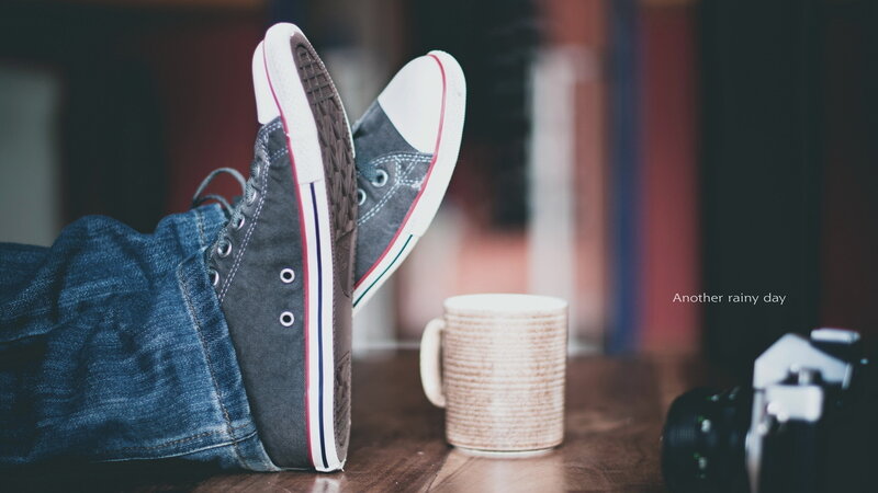 Feet in Sneakers on Table