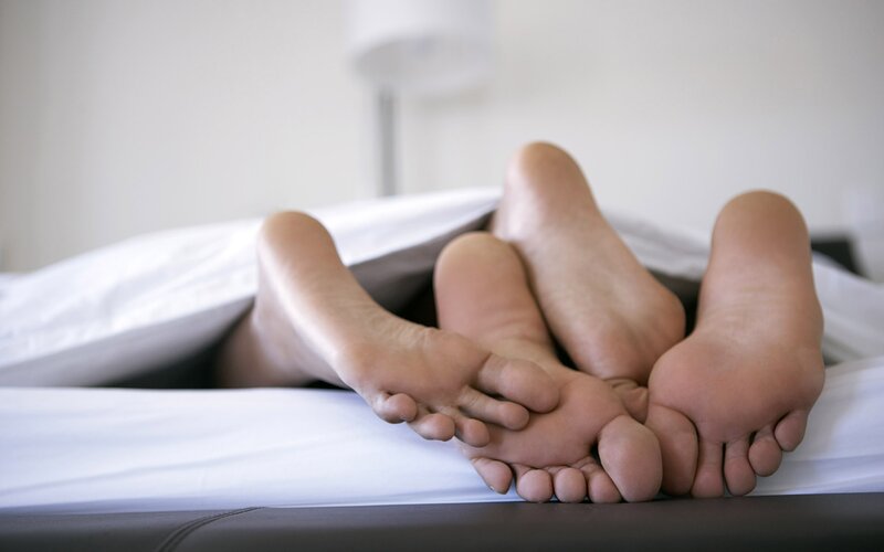 feet of two people in bed