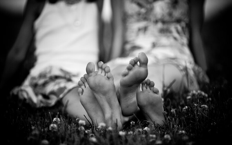 feet of two people on grass